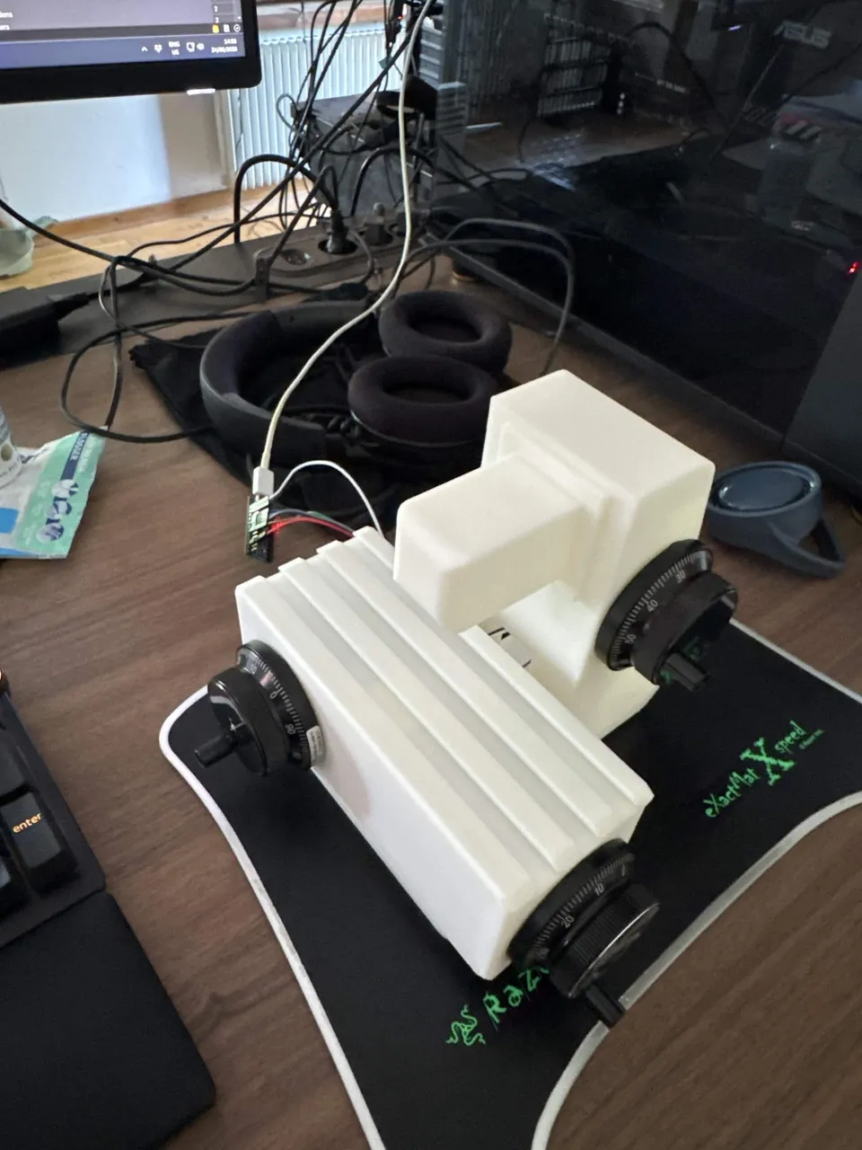 The controller on a desk, connected over USB next to a keyboard